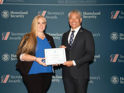 Team Excellence Award recipient, Rebekah Tucker, with DHS Deputy Secretary John Tien.