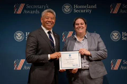 DHS Deputy Secretary John Tien with Team Excellence Award recipient, Emily Hymowitz.