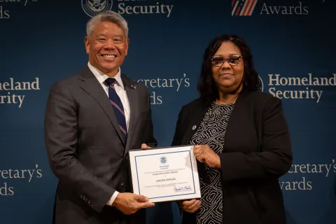 DHS Deputy Secretary John Tien with Team Excellence Award recipient, Sandra Debnam.
