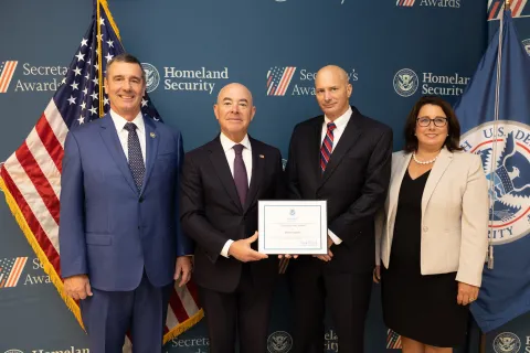 Left to right: Transportation Security Administration (TSA) Administrator David Pekoske, DHS Secretary Alejandro Mayorkas, Team Excellence Award recipient Kevin Gaddis, and TSA Senior Official Performing the Duties of the Deputy Administrator Stacey Fitzmaurice.