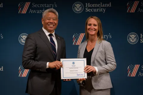 DHS Deputy Secretary John Tien with Leadership Excellence Award recipient, Morgan Plumer.