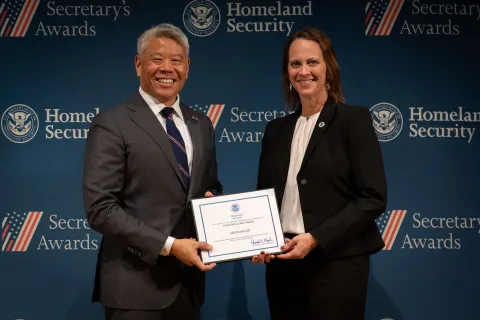 DHS Deputy Secretary John Tien with Team Excellence Award recipient, Aeron Miller.