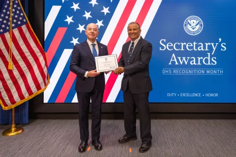 DHS Secretary Alejandro Mayorkas with Team Excellence Award recipient, Ramsey S. Razick.