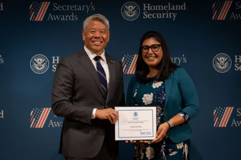 DHS Deputy Secretary John Tien with Team Excellence Award recipient, Sikina Hasham.