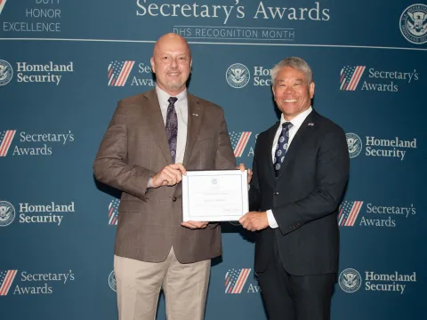 Team Excellence Award recipient, Bradley Lawrence, with DHS Deputy Secretary John Tien.