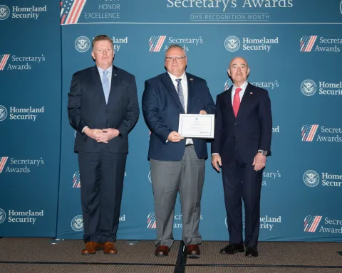 Caption: Left to right: U.S. Secret Service Director James Murray, Innovation Award recipient Thomas D. Novak, and DHS Secretary Alejandro Mayorkas.