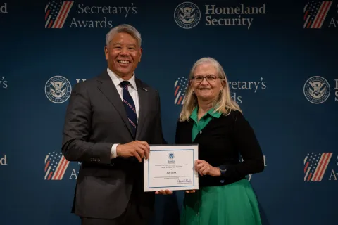 DHS Deputy Secretary John Tien with Team Excellence Award recipient, Amy Bunk.