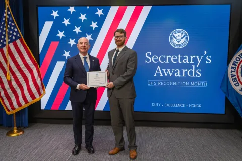 DHS Secretary Alejandro Mayorkas with Innovation Award recipient, Iain Deason.