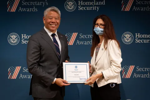 DHS Deputy Secretary John Tien with Team Excellence Award recipient, Rose Bird.
