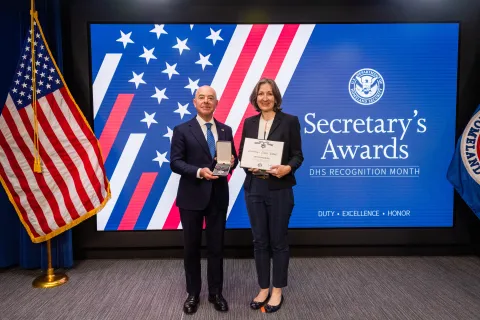 DHS Secretary Alejandro Mayorkas with Secretary's Silver Medal recipient, Dr. Ann Schneider.