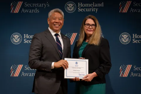 DHS Deputy Secretary John Tien with Team Excellence Award recipient, Tamara Molina.