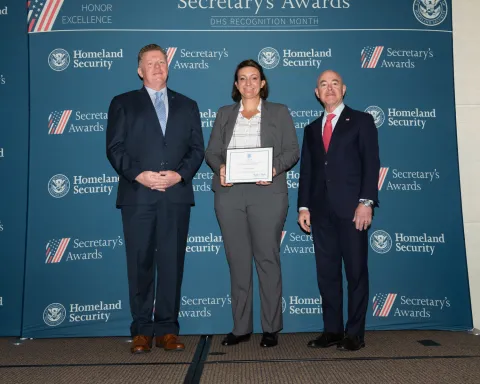 Left to right: U.S. Secret Service Director James Murray, Team Excellence Award recipient Jessica Casey, and DHS Secretary Alejandro Mayorkas.
