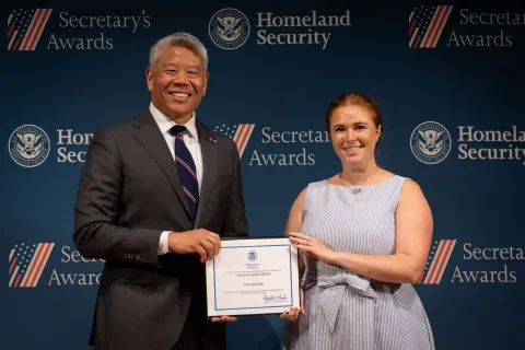 DHS Deputy Secretary John Tien with Team Excellence Award recipient, Caitlin Finn.
