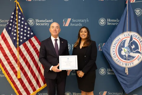 DHS Secretary Alejandro Mayorkas with Team Excellence Award recipient, Benish Anver.