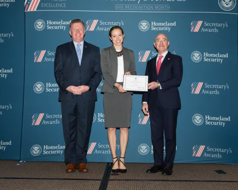 Left to right: U.S. Secret Service Director James Murray, Team Excellence Award recipient Emily Patten, and DHS Secretary Alejandro Mayorkas.
