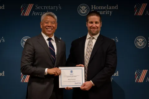 DHS Deputy Secretary John Tien with Team Excellence Award recipient, Brian Puchalsky.