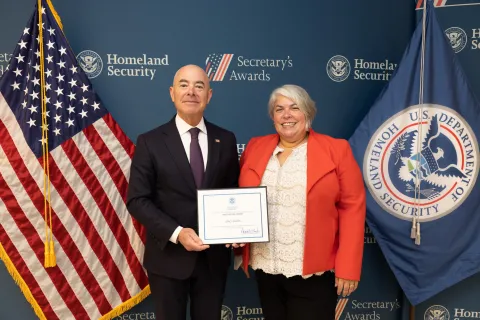 DHS Secretary Alejandro Mayorkas with Innovation Award recipient Stacy Shore.