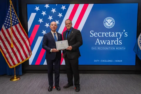 DHS Secretary Alejandro Mayorkas with Innovation Award recipient, Cory J. Smith.