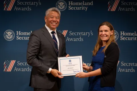 DHS Deputy Secretary John Tien with Team Excellence Award recipient, Amy Bennett.