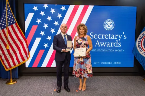 DHS Secretary Alejandro Mayorkas and Secretary's Gold Medal recipient Christine Lewandowski.