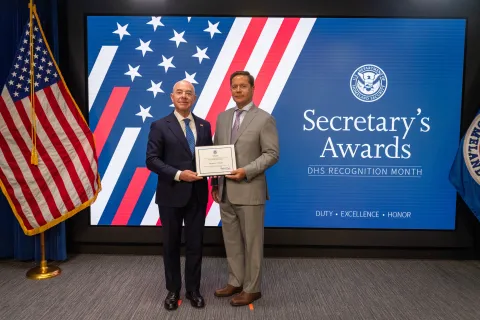 DHS Secretary Alejandro Mayorkas with Team Excellence Award recipient, Thomas A. Tomaiko.