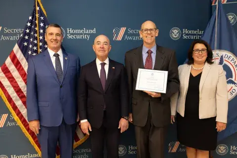 Left to right: Transportation Security Administration (TSA) Administrator David Pekoske, DHS Secretary Alejandro Mayorkas, Team Excellence Award recipient Charles Phillips, and TSA Senior Official Performing the Duties of the Deputy Administrator Stacey Fitzmaurice.