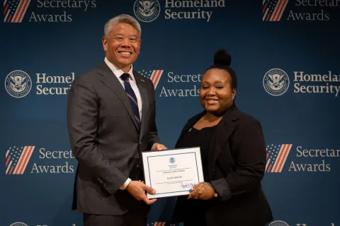 DHS Deputy Secretary John Tien with Team Excellence Award recipient, Allexis Baylor.