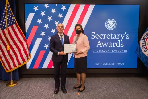 DHS Secretary Alejandro Mayorkas with Team Excellence Award recipient,  Sharon M. Wong.