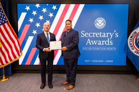 DHS Secretary Alejandro Mayorkas with Team Excellence Award recipient,  Jose Villafane.
