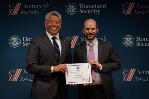 DHS Deputy Secretary John Tien with Team Excellence Award recipient, Patrick Bruce.