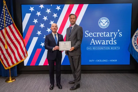 DHS Secretary Alejandro Mayorkas with Innovation Award recipient, Michael P. Reid.