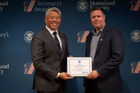DHS Deputy Secretary John Tien with Team Excellence Award recipient, Jimmy Wolfrey.
