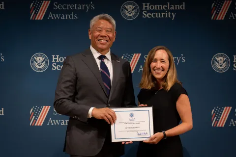 DHS Deputy Secretary John Tien with Team Excellence Award recipient, Catherine Schaper.