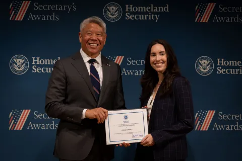 DHS Deputy Secretary John Tien with Team Excellence Award recipient, Jessica Yarnes.