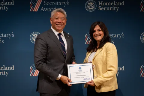 DHS Deputy Secretary John Tien with Team Excellence Award recipient, Catrina Pavlik-Keenan.