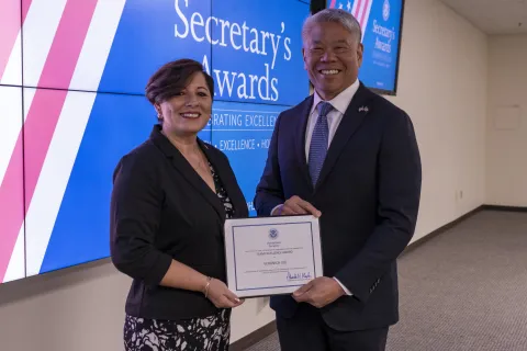 Team Excellence Award recipient, Veronica Lile with DHS Deputy Secretary John Tien. 