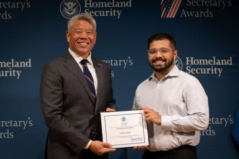 DHS Deputy Secretary John Tien with Team Excellence Award recipient, Farhat Karim.