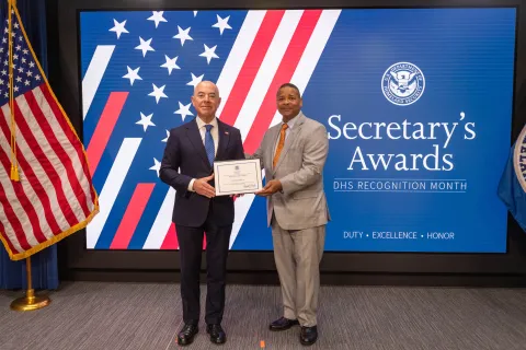 DHS Secretary Alejandro Mayorkas with Team Excellence Award recipient,  Victor Lopez, Jr. 
