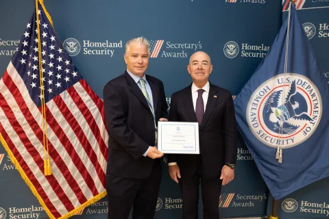 Innovation Award recipient Christopher J. Nigh with DHS Secretary Alejandro Mayorkas.