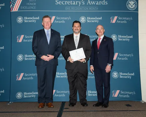 Left to right: U.S. Secret Service Director James Murray, Team Excellence Award recipient Majd Alkassem, and DHS Secretary Alejandro Mayorkas.