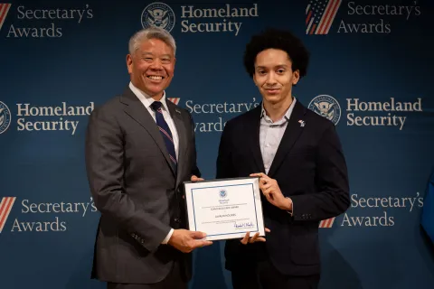 DHS Deputy Secretary John Tien with Team Excellence Award recipient, JoVaun Holmes.