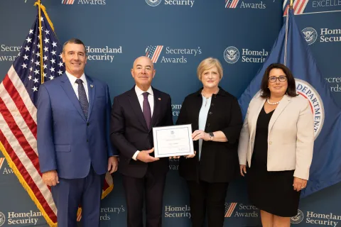 Left to right: Transportation Security Administration (TSA) Administrator David Pekoske, DHS Secretary Alejandro Mayorkas, Team Excellence Award recipient Tracy Klemm, and TSA Senior Official Performing the Duties of the Deputy Administrator Stacey Fitzmaurice.