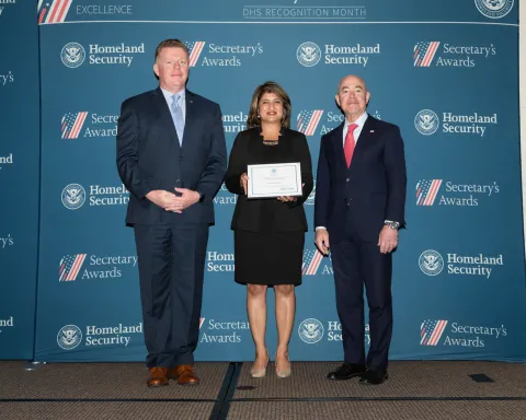 Left to right: U.S. Secret Service Director James Murray, Team Excellence Award recipient Meera Kumar, and DHS Secretary Alejandro Mayorkas.