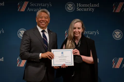 DHS Deputy Secretary John Tien with Team Excellence Award recipient, Hillary Hunnings.