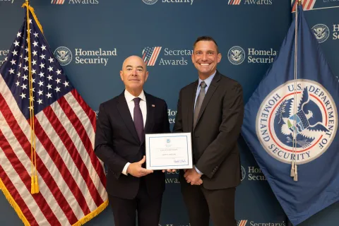 DHS Secretary Alejandro Mayorkas with Team Excellence Award recipient, Scott P. Whelan.