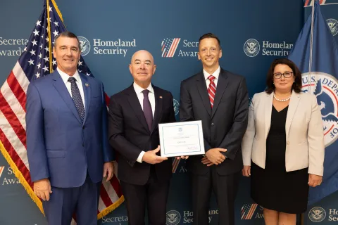 Left to right: Transportation Security Administration (TSA) Administrator David Pekoske, DHS Secretary Alejandro Mayorkas, Team Excellence Award recipient Gary Click, and TSA Senior Official Performing the Duties of the Deputy Administrator Stacey Fitzmaurice.