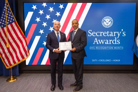 DHS Secretary Alejandro Mayorkas with Team Excellence Award recipient,  Jeffrey A. Wilson.