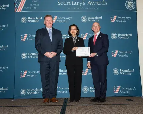 Left to right: U.S. Secret Service Director James Murray, Team Excellence Award recipient Christina Trinh, and DHS Secretary Alejandro Mayorkas.