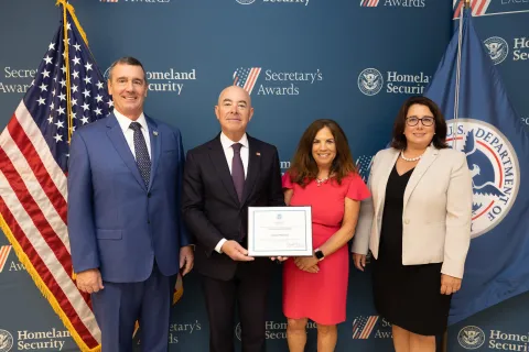 Left to right: Transportation Security Administration (TSA) Administrator David Pekoske, DHS Secretary Alejandro Mayorkas, Team Excellence Award recipient Susan Prosnitz, and TSA Senior Official Performing the Duties of the Deputy Administrator Stacey Fitzmaurice.