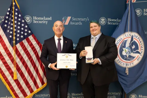DHS Secretary Alejandro Mayorkas with Secretary's Gold Medal recipient, Sarah A. Duff.